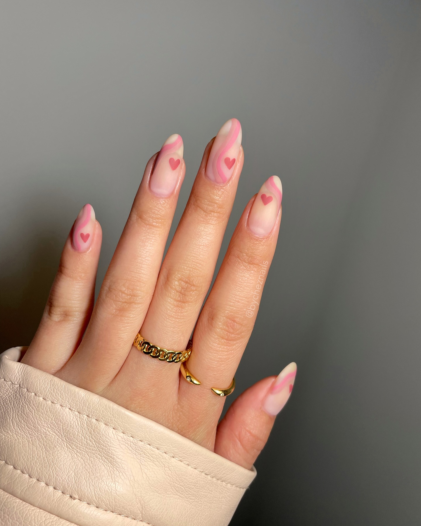 Pink nails with minimalist gold dash accents.