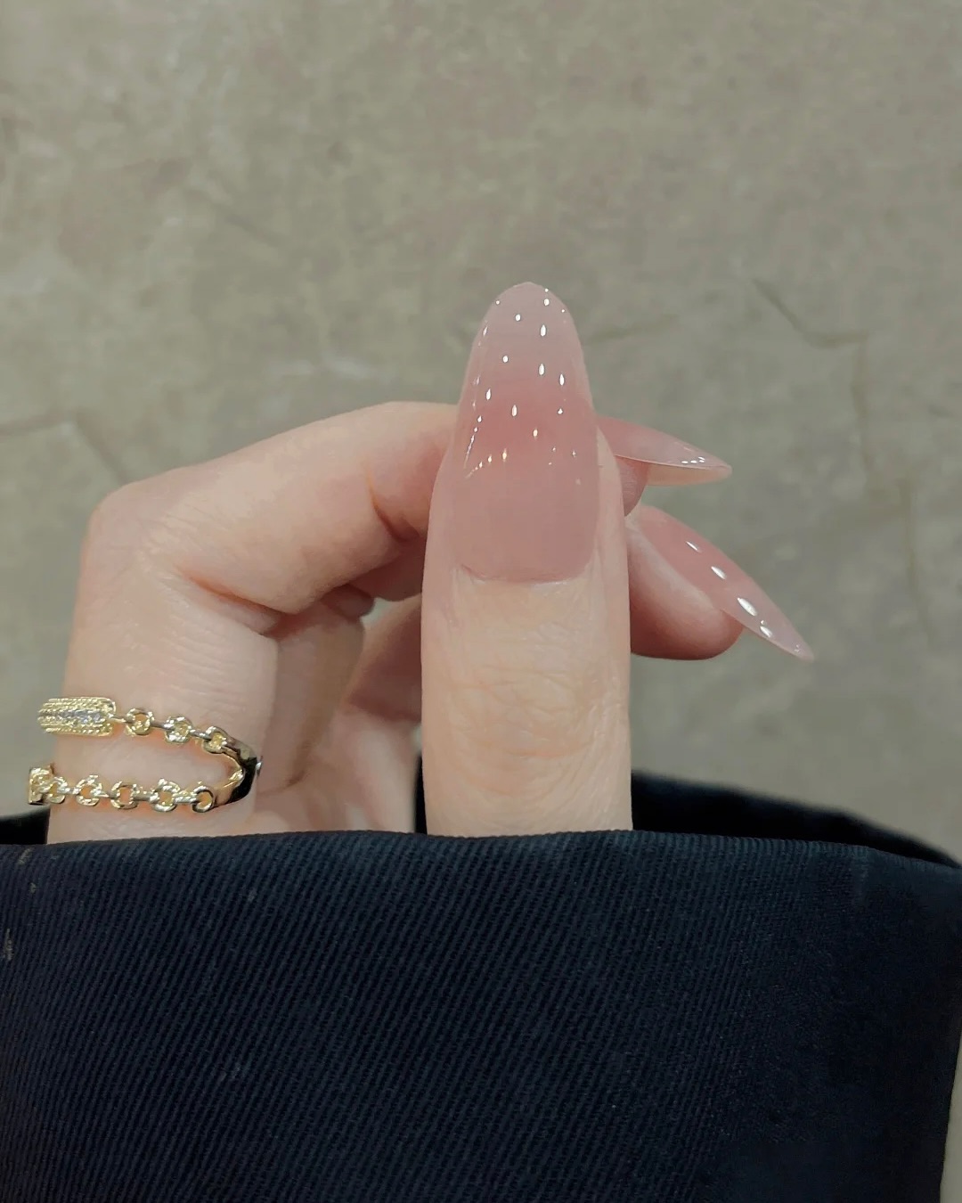 Green marble effect nails with gold foil accents.