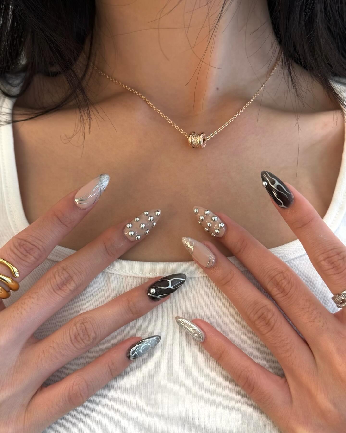 Sheer pink nails with botanical gold and green tips.