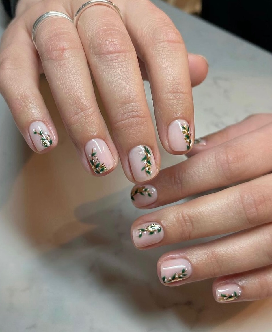 Olive green nails with framed floral art details.