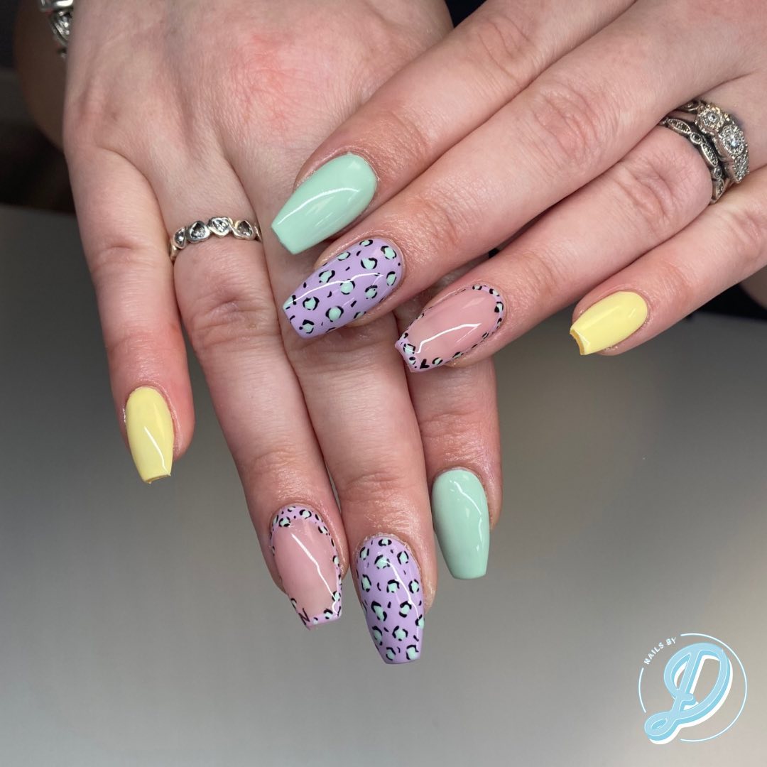 Pastel leopard print nails with colored tips.